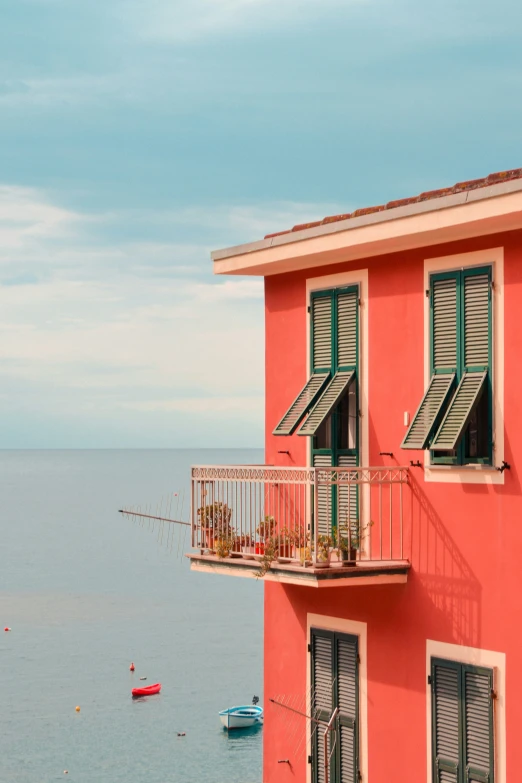 a red building sitting next to an ocean