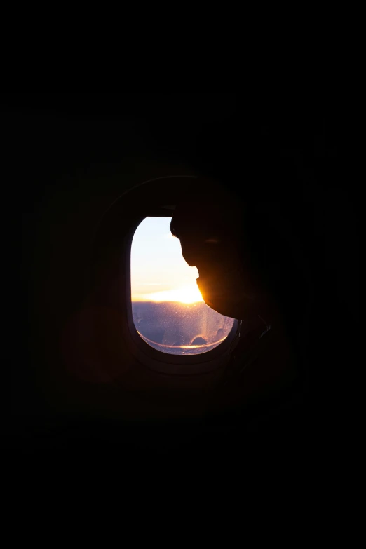 an airplane window overlooking the sky and clouds