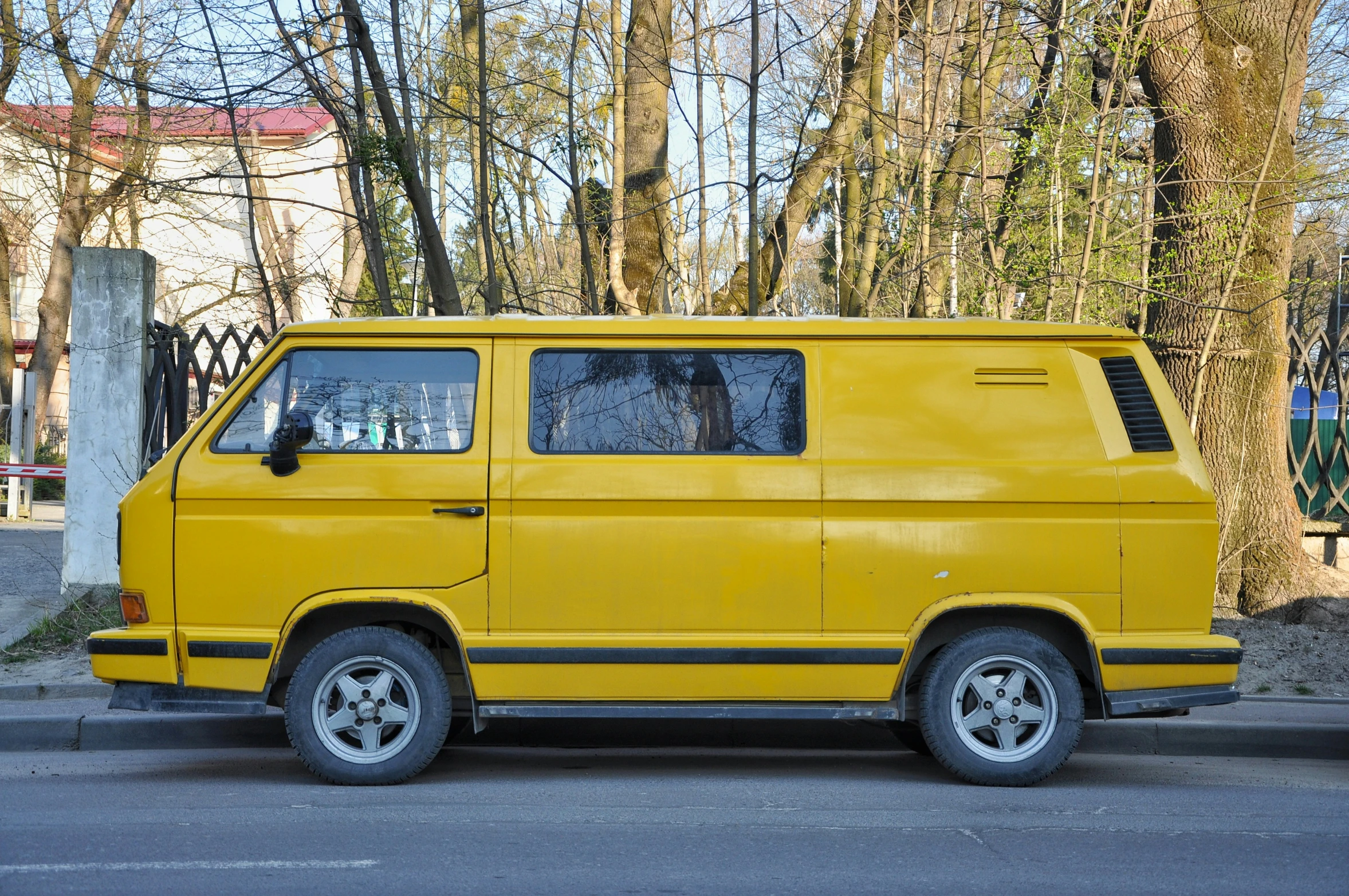 a bright yellow van parked on a street