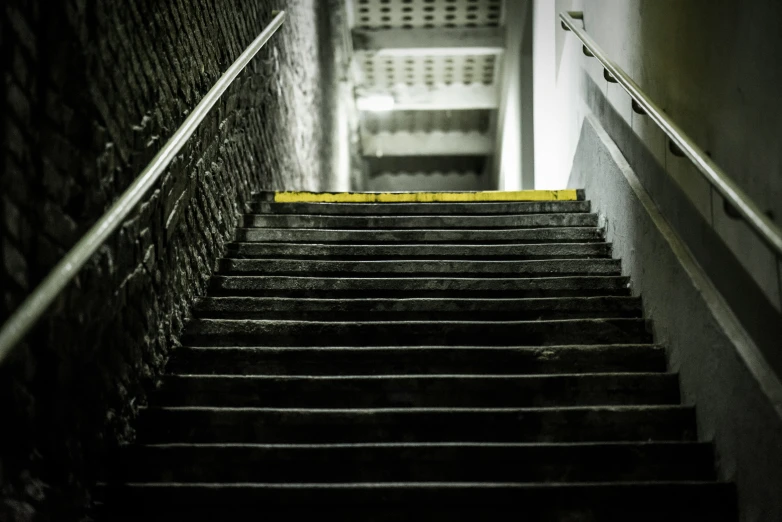 stairs and railing leading to a hallway next to a door