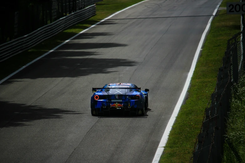 a blue race car on an empty track