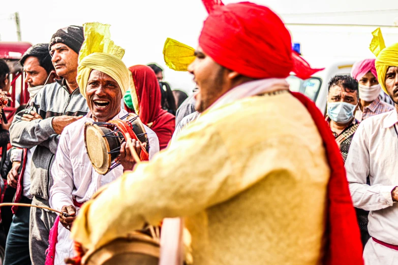 the people are gathered together in colorful head coverings