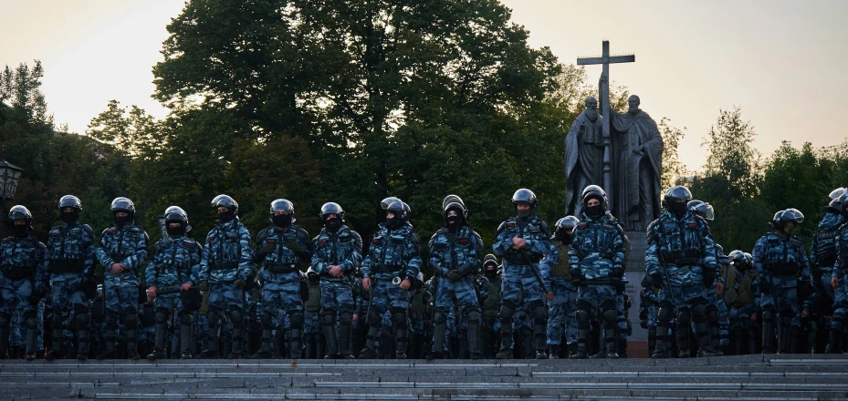 police officers standing in front of a cross