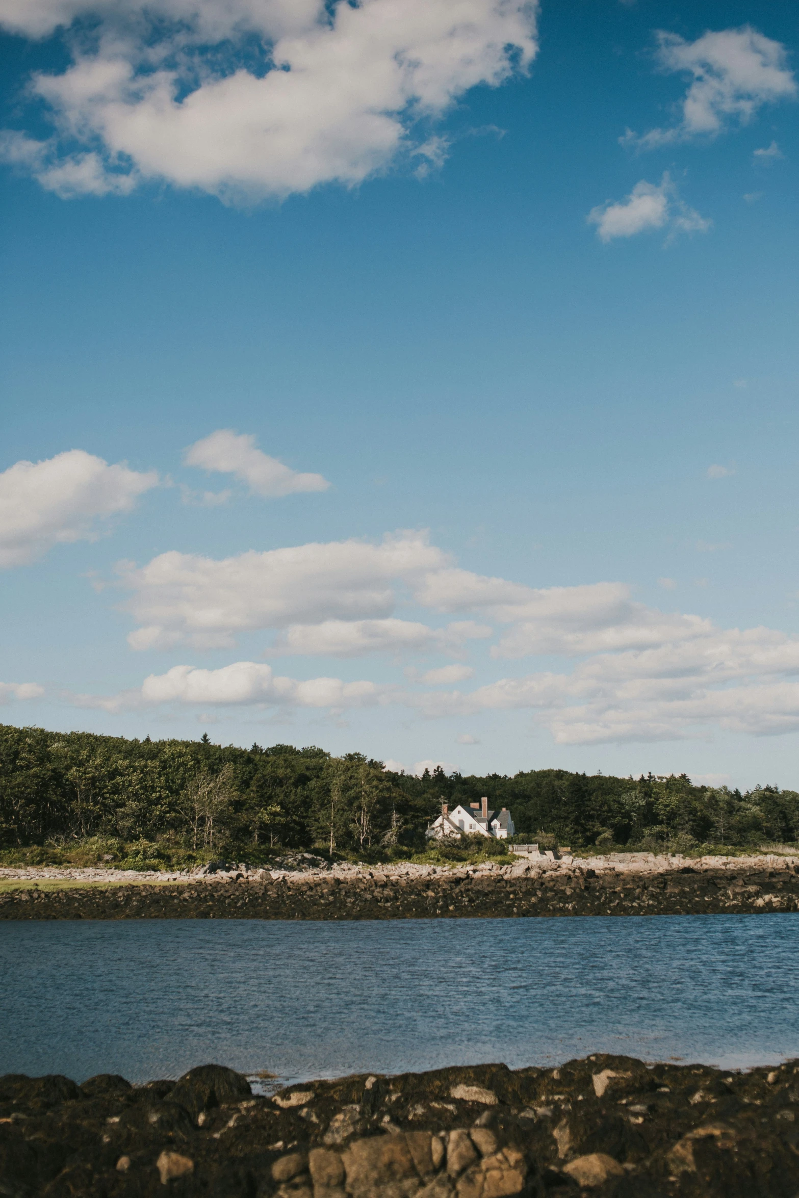 a kite flying over water and lots of land