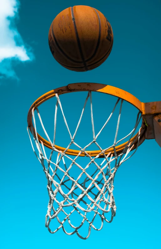 a basketball is coming into a net to hit a ball