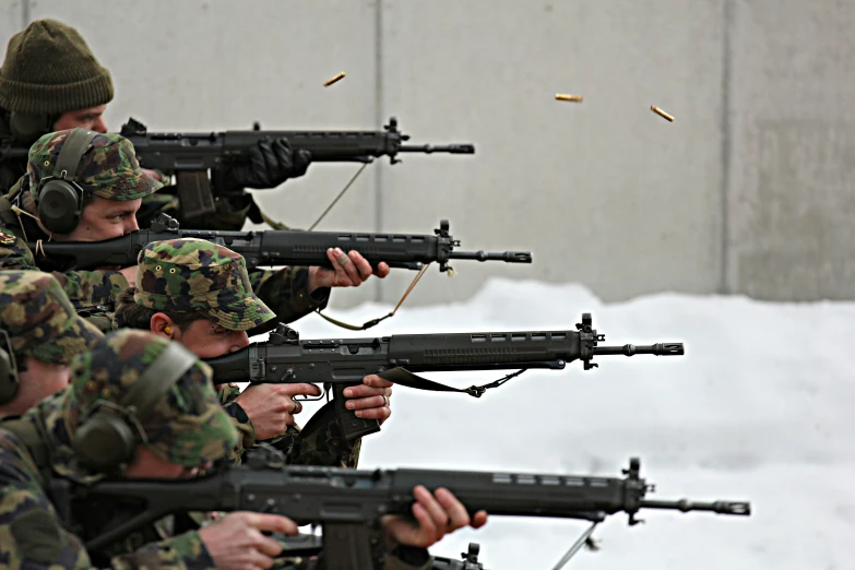 armed men from an army unit holding a range of gun shells