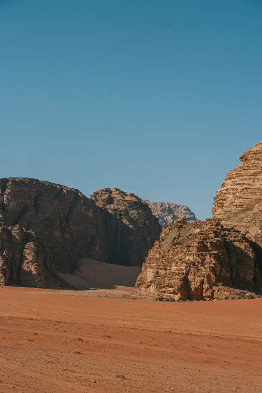 some desert with no grass and rocks in the background