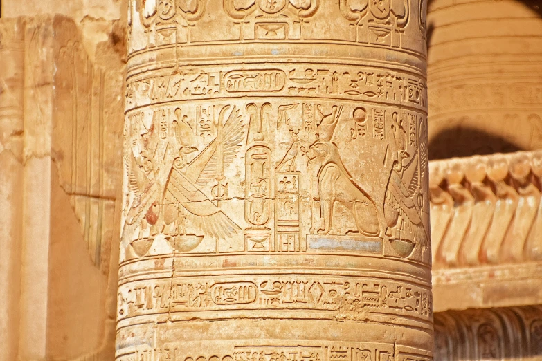 an old stone pillar has writing on it