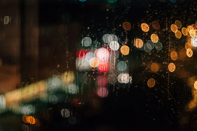 rain drops hitting from a window at night