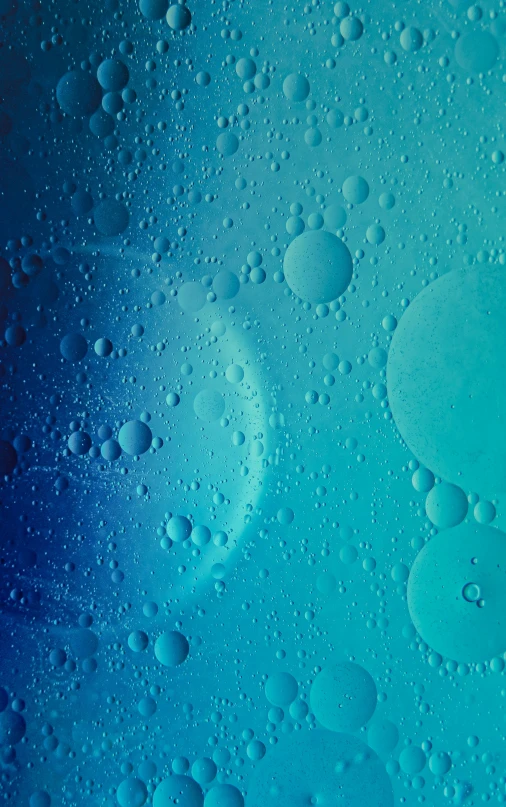 a large blue liquid or substance with some drops