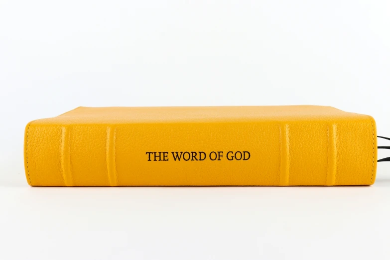 yellow book with black lettering on white surface