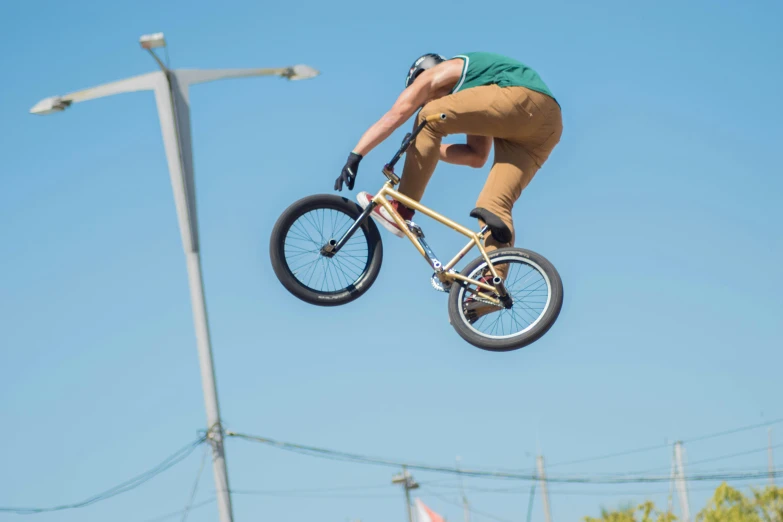 the man jumps a bicycle in a stunt