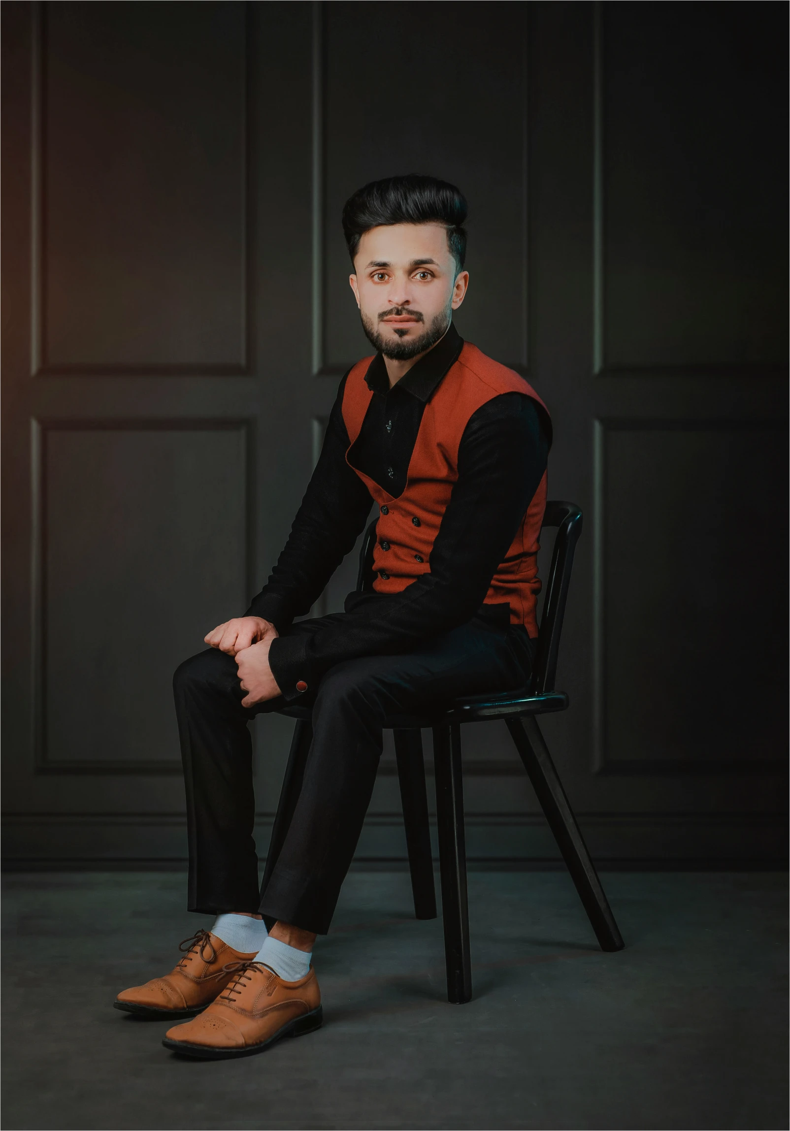 man sitting on chair in pose for pograph