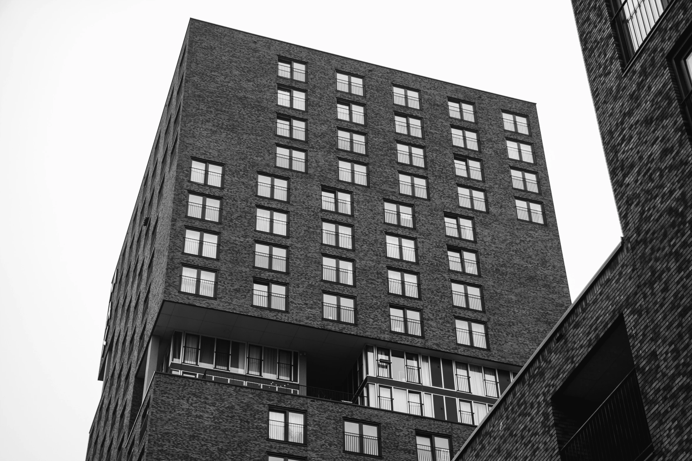 black and white po of a tall building and window shutters