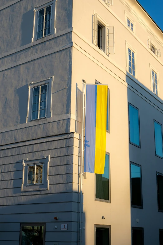 a white building with several windows and blue shutters