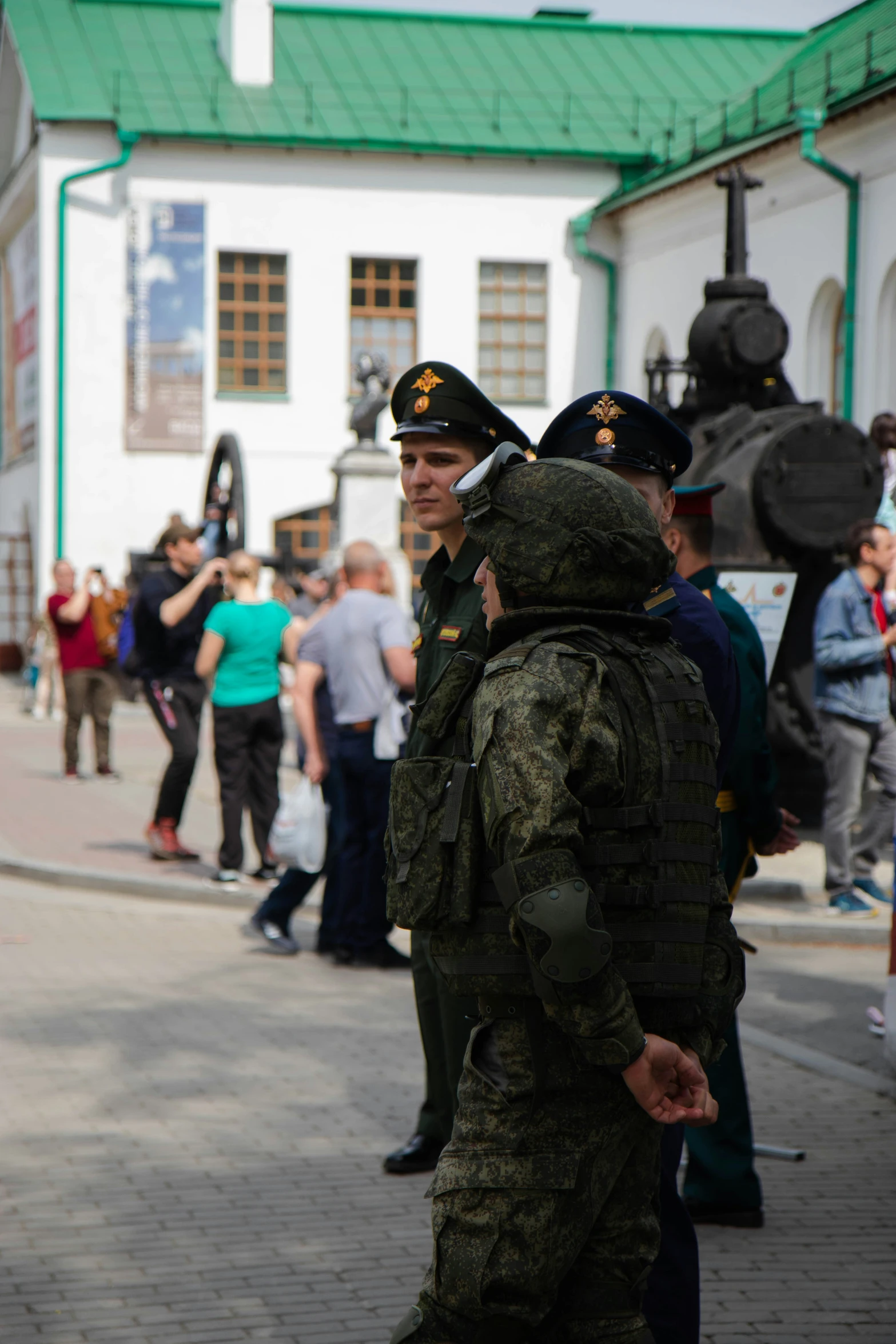 two men in uniforms and one standing outside