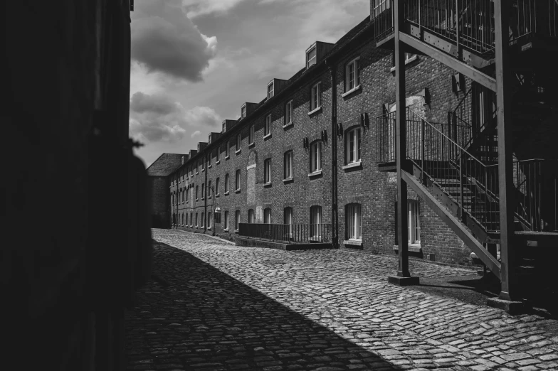 two buildings next to each other and an empty cobblestone street