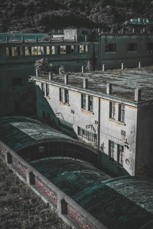 an old white building next to a bridge