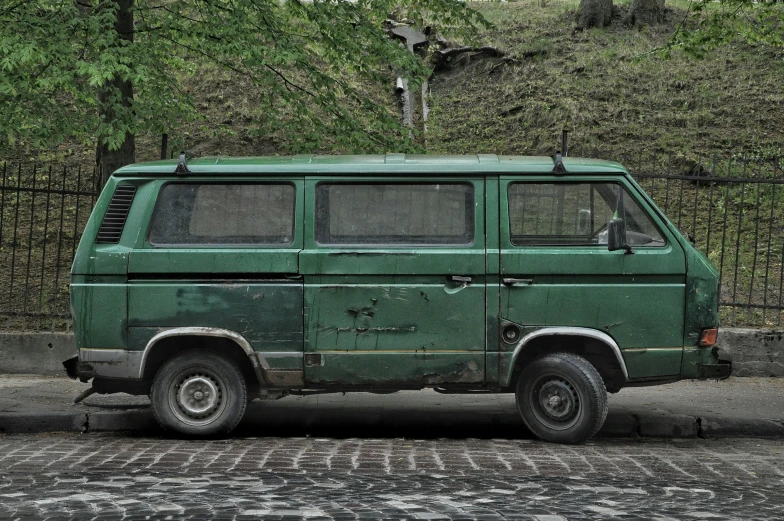 an old van that is parked in the street