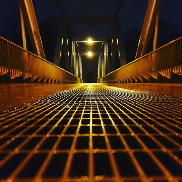 an empty walkway with lights shine on it