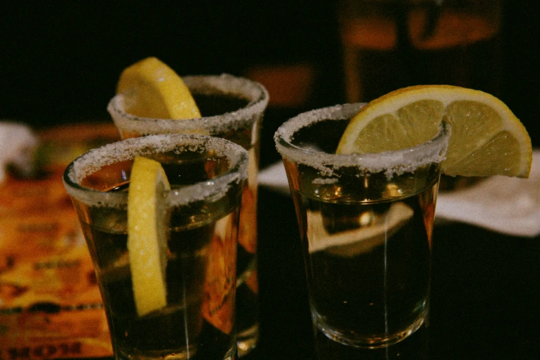 two s glasses with ice and lemon slices