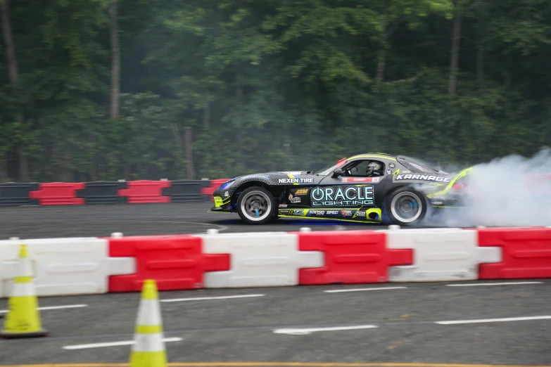 a drift car is turning around while driving around a track