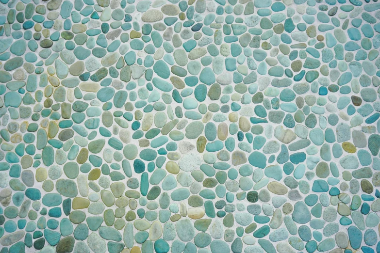 several very pretty blue and green pebbles on concrete