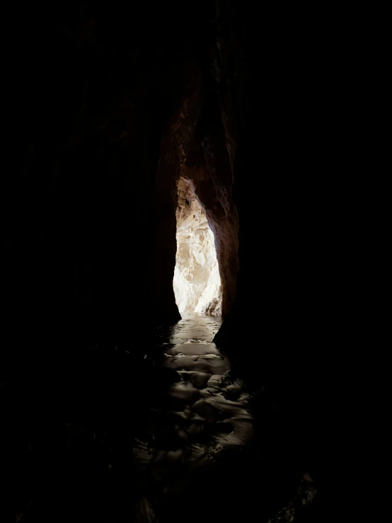 an open door in the cave is glowing light