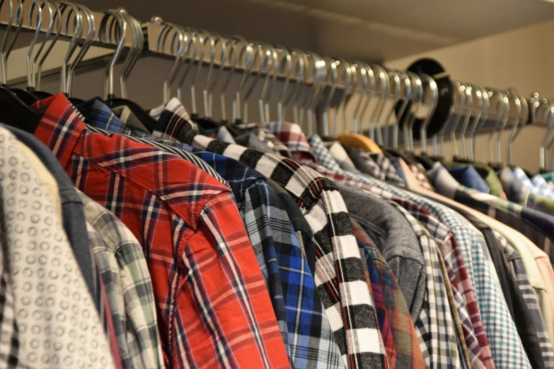 men's shirts hanging on a rack together