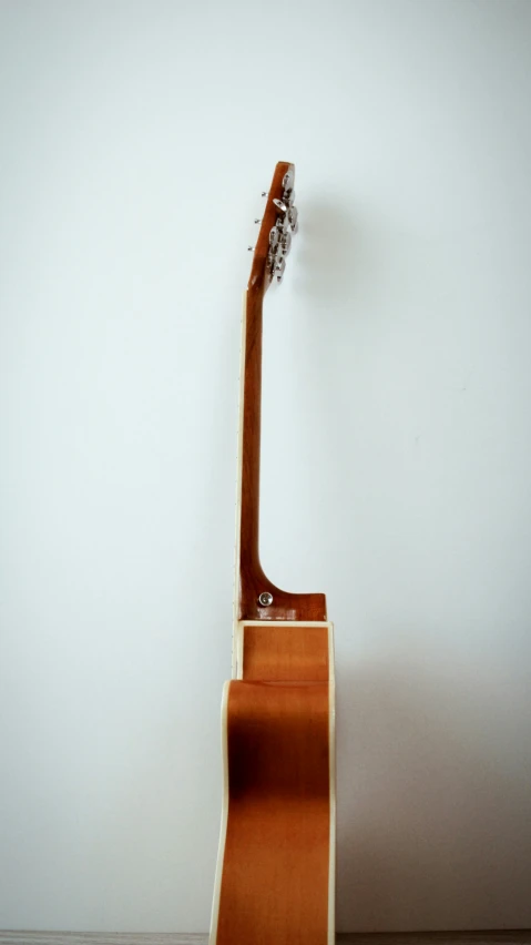 a guitar sitting on the wall with a guitar sticking out