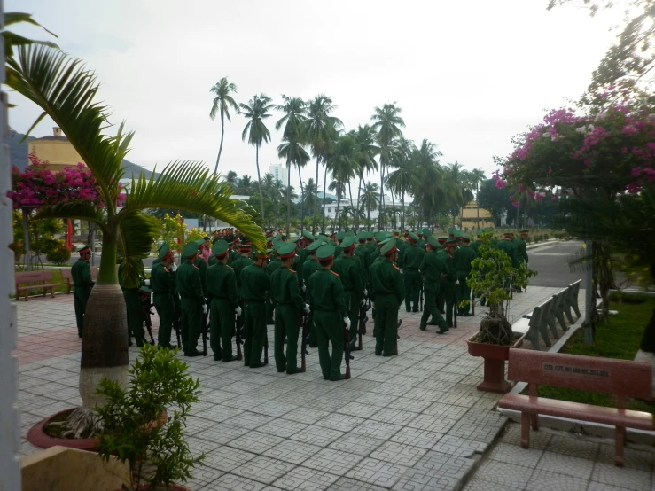 several soldiers are gathered at a memorial in the park