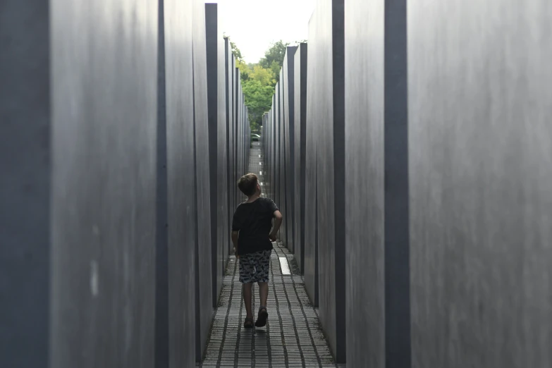 a woman walks through a long narrow hallway