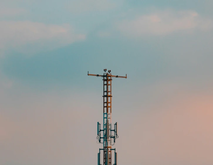 an airplane is flying over the antenna and wires