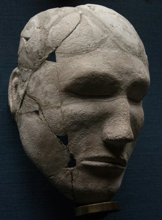 a close up of a plaster head on a black background
