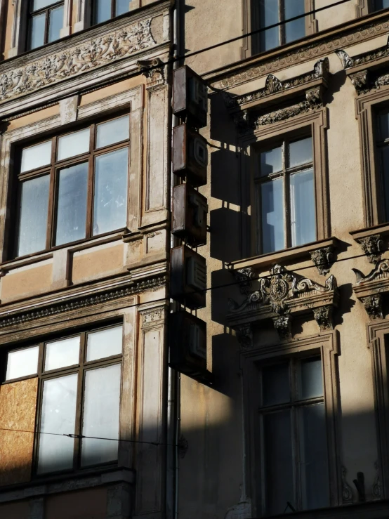 an old building with two windows and no curtains