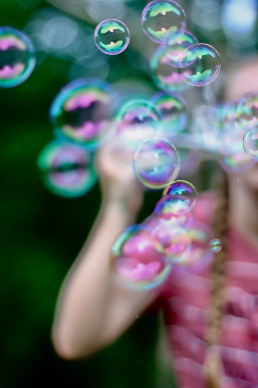 the girl is blowing soap bubbles all around