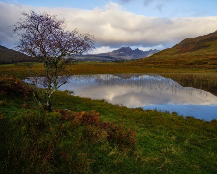 a small lake on the side of a hill