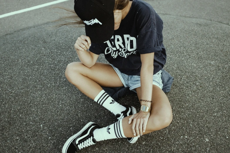 a woman sitting on the ground with her feet up