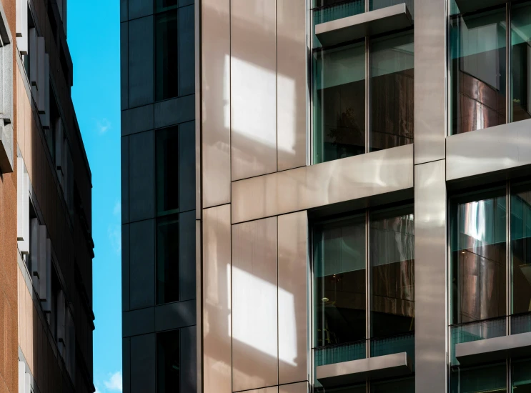 two large buildings on a street near a blue sky