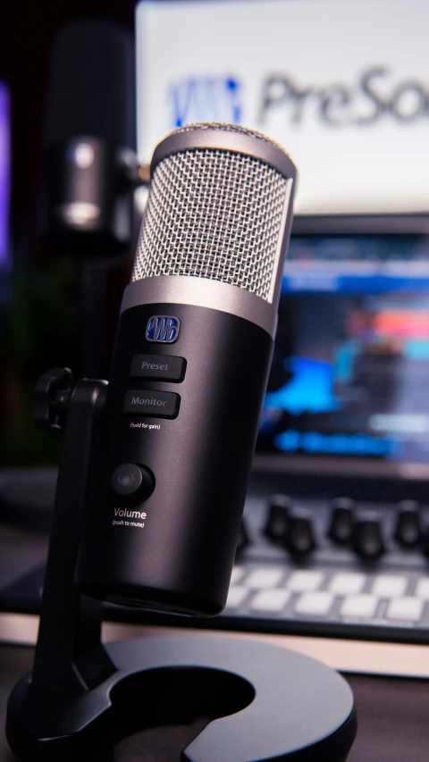 a microphone is attached to a laptop next to an ipod