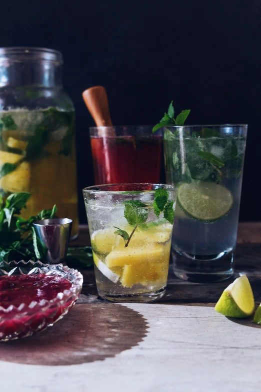 three glasses are filled with some fruit and vegetables