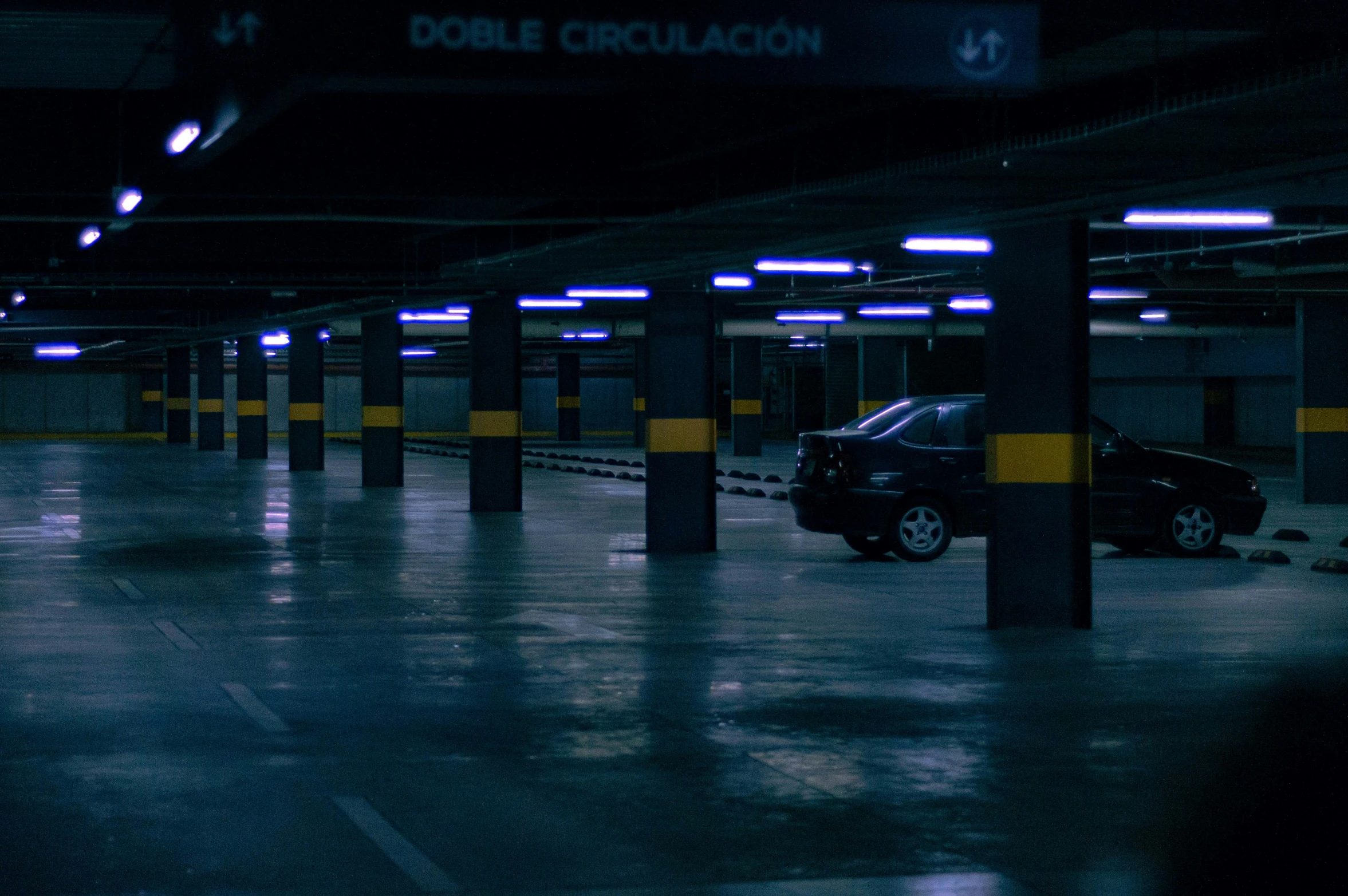 a car sits parked in an empty parking lot