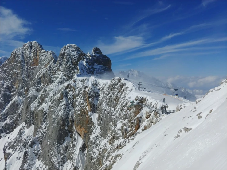 a view of snow covered mountain sides in the daytime