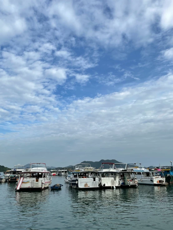 many boats are parked at the pier in the water