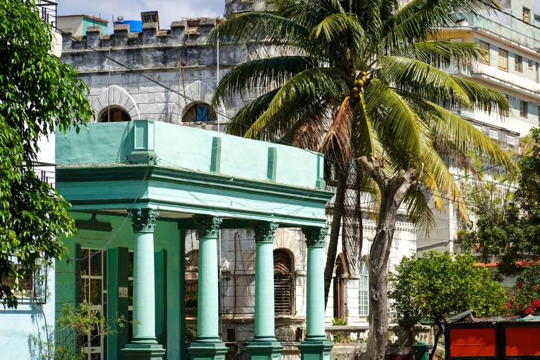 a blue gazebo sits in the middle of the street