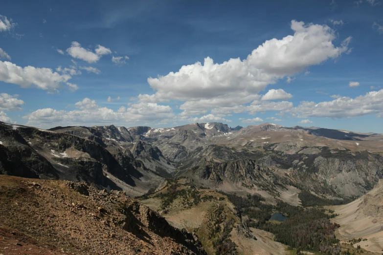 some very pretty mountain ranges under a blue cloudy sky