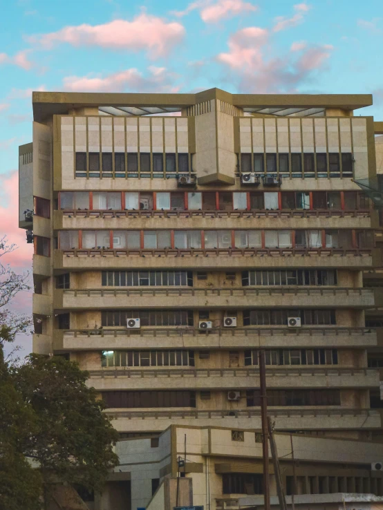 an old building with balconies and red windows