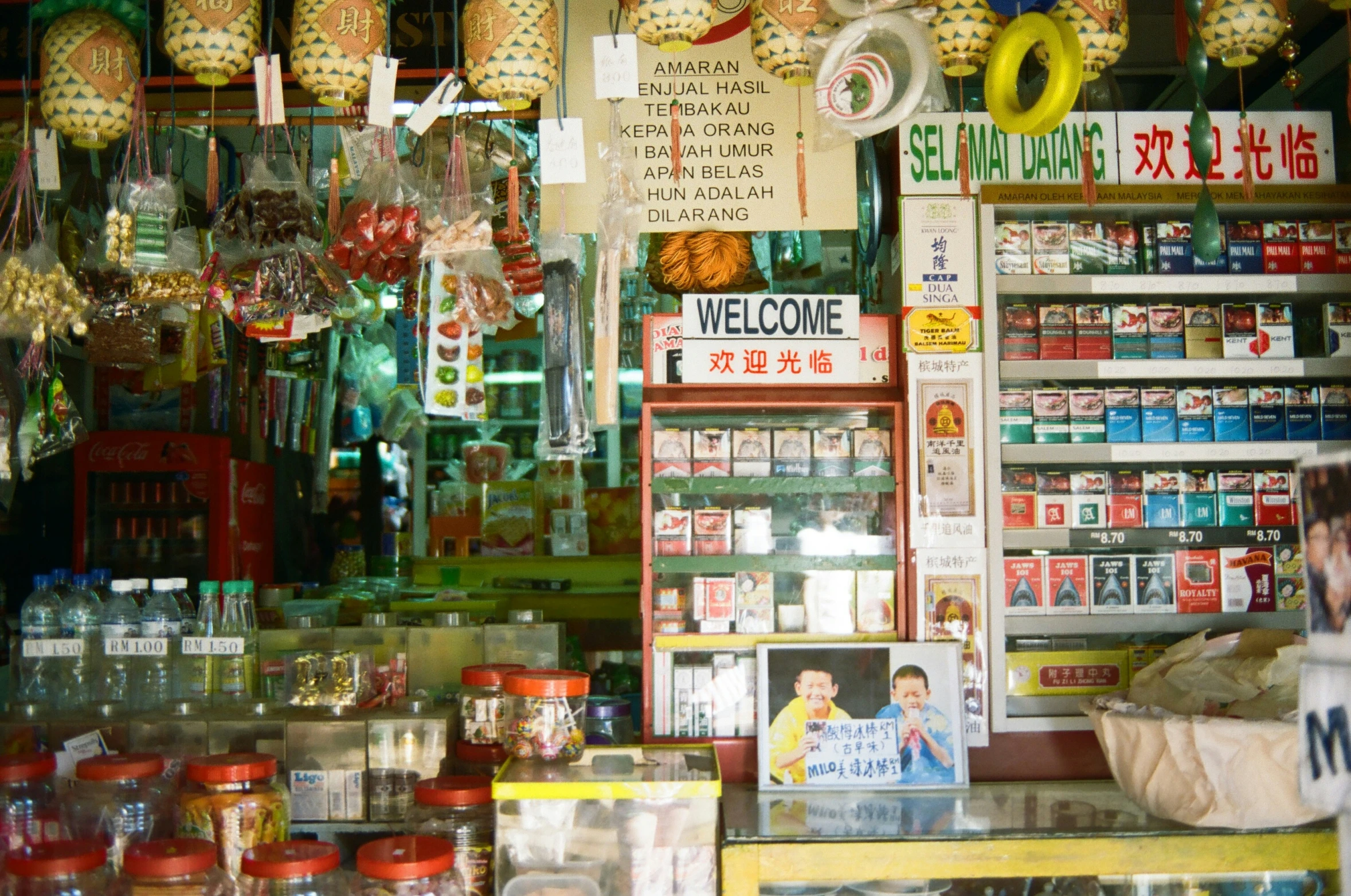 a street vendor selling various items inside a market