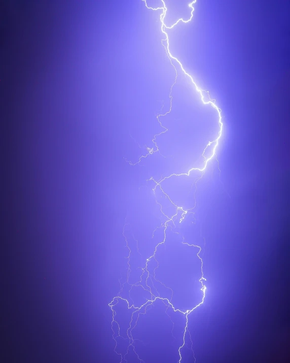 a lightning storm strikes brightly over the ground