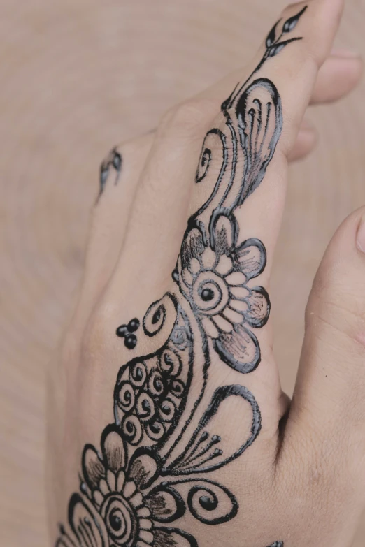 a woman showing off her hand and tattoo